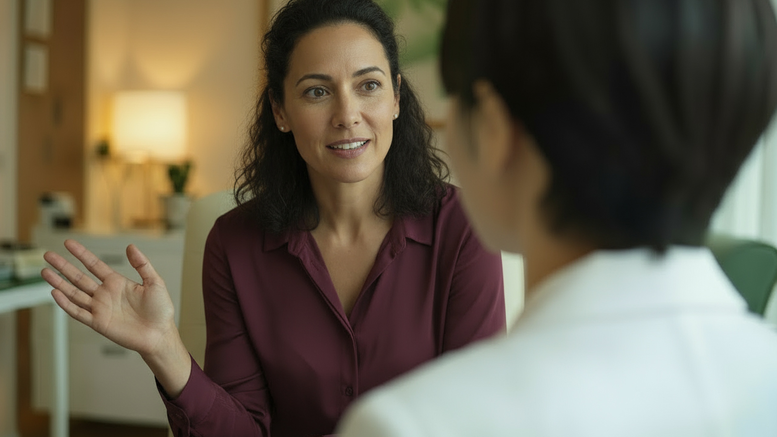 Woman speaking with a physician in a calm, modern office, representing personalized care and comprehensive pain consultations